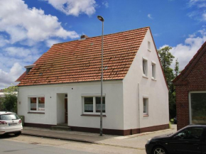 Apartment in Carolinensiel with a high chair and bed